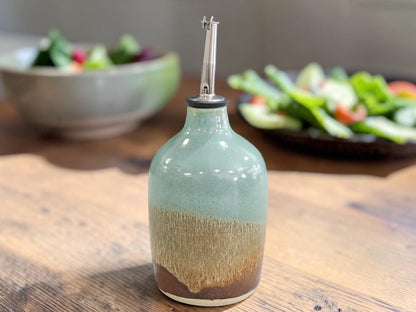 green and brown 400 ml oil pourer on a timber bench top.