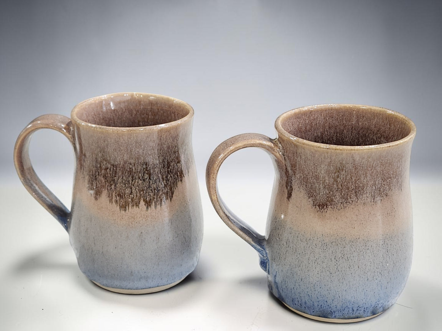 Handmade pottery mug set in oatmeal and blue tones, wheel-thrown ceramics from Australia