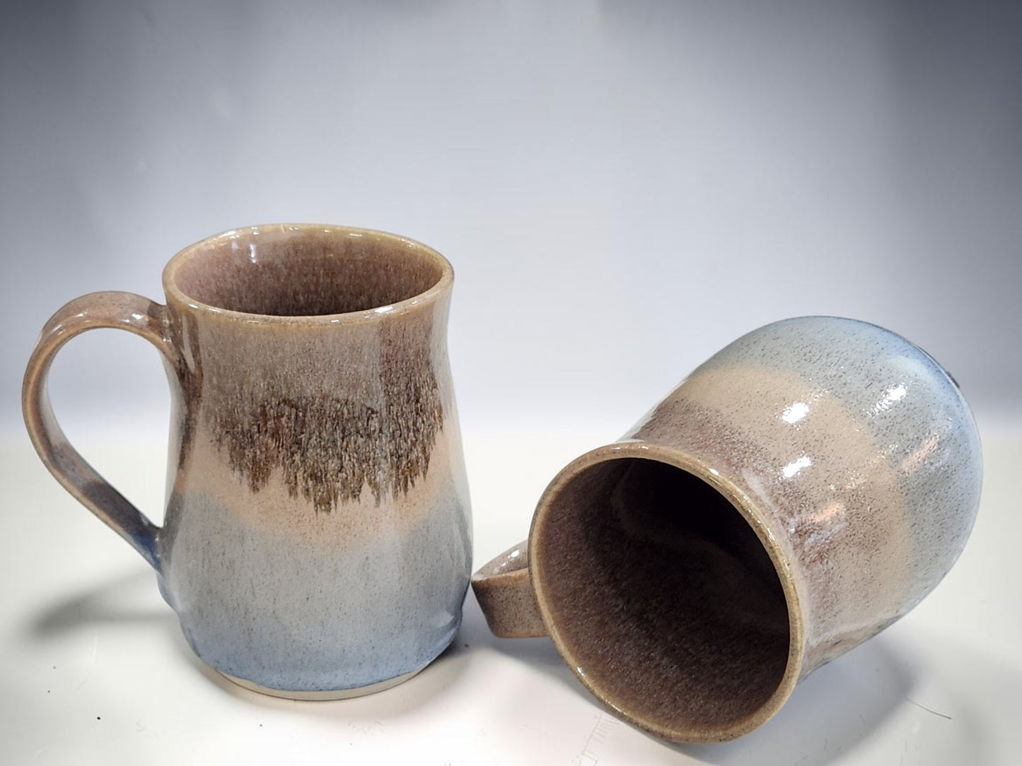 Group of handmade stoneware mugs in soft oatmeal and blue glaze, unique pottery gift from Melbourne