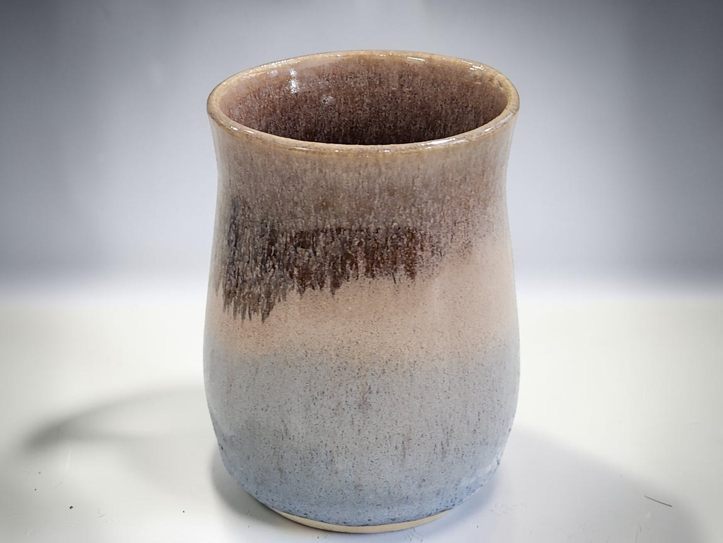 Handmade ceramic mug with soft blue base and oatmeal glaze, rustic 400 ml tea mug