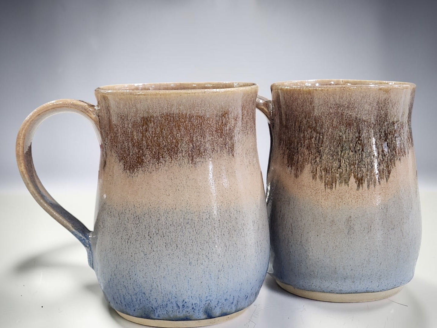 Collection of 400 ml handmade ceramic mugs with earthy oatmeal and blue finish, artisan pottery Australia