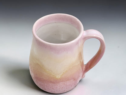 Wheel-thrown ceramic mug measuring 11cm tall with an 8.5cm belly