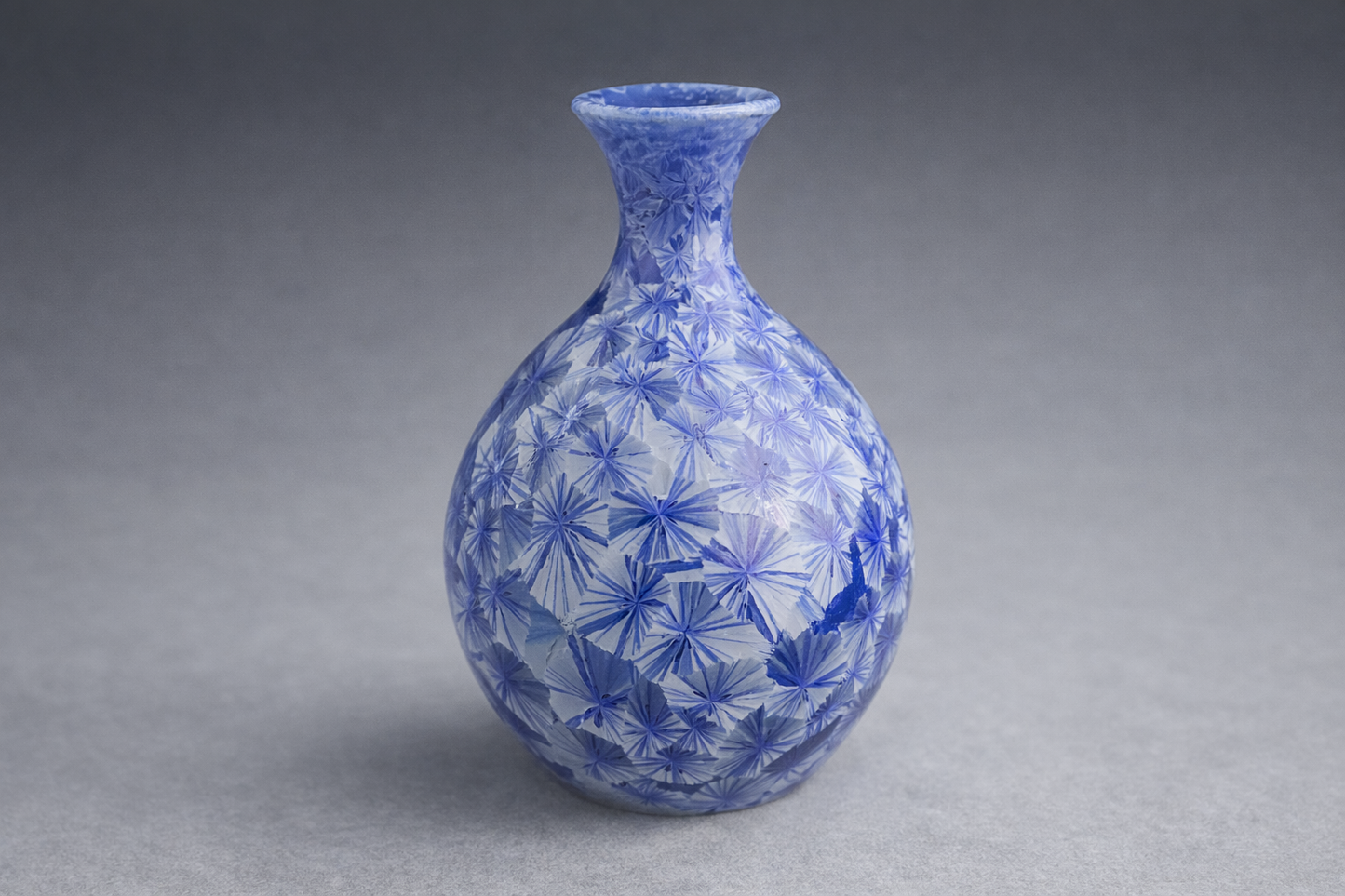 Handmade blue crystalline glaze bud vase, Melbourne studio ceramics, grey studio background