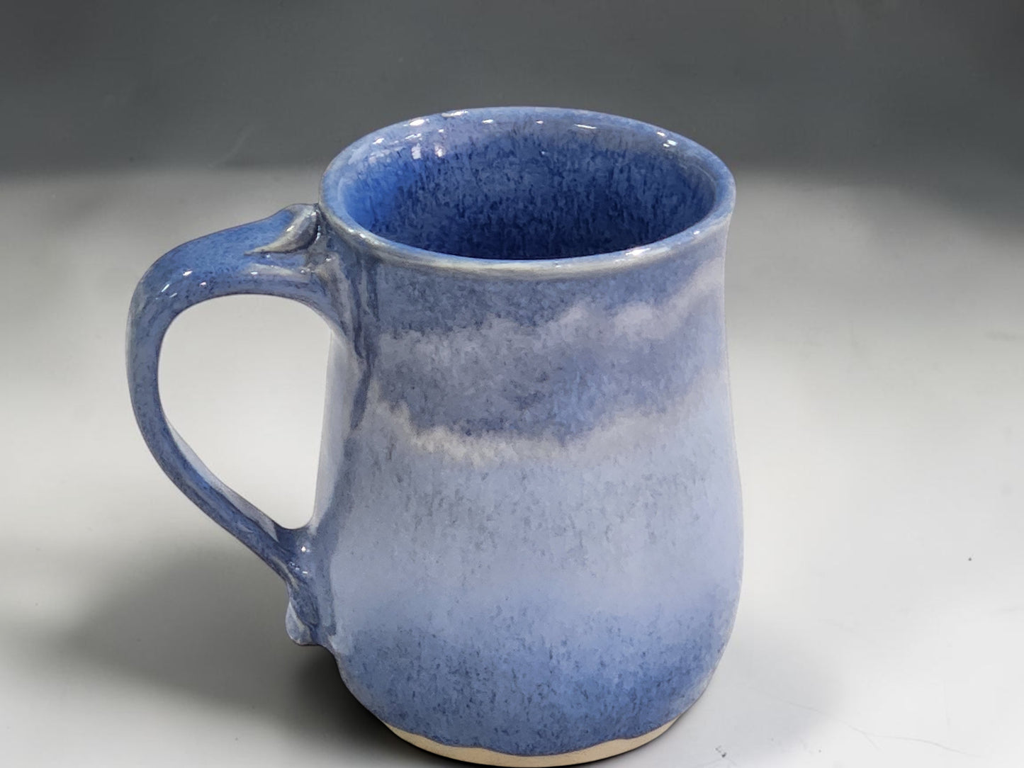 Handmade ceramic mug with layered blue and grey glaze tones