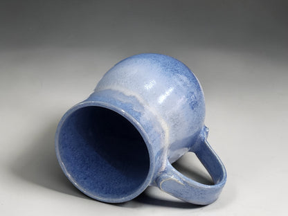 One-of-a-kind blue stoneware mug with organic glaze movement