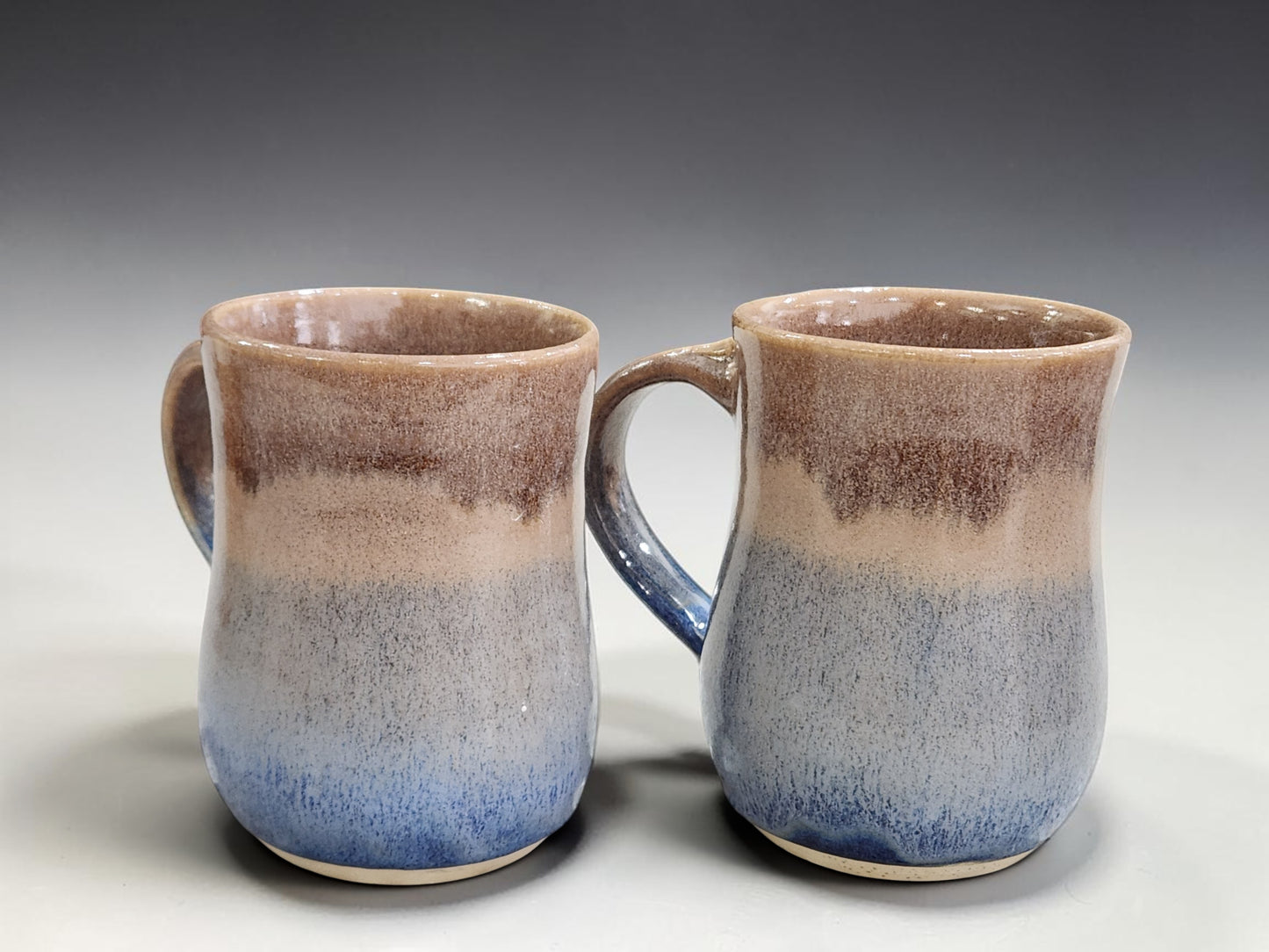 Pair of handcrafted Australian stoneware mugs with blue and brown gradient glaze