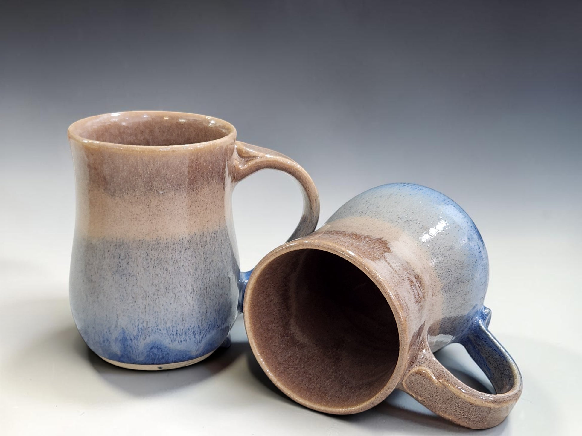 Handmade Australian pottery mug with oatmeal brown and soft blue glaze holding 500ml