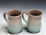 Large handmade pottery mugs by Buxton Pottery in earthy blue and oatmeal tones