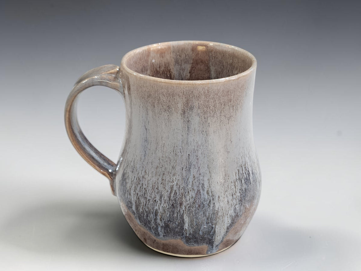 Side view showing the rounded body and curved handle of large handmade mug