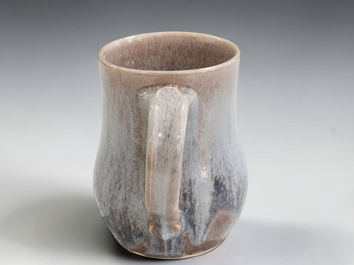 Tall rounded ceramic mug with comfortable loop handle