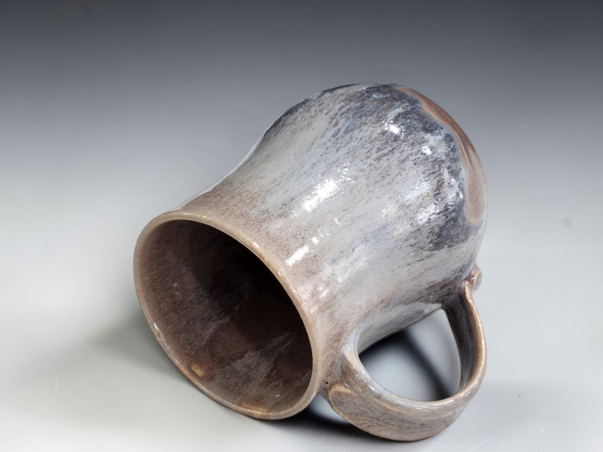 Large blue and brown glazed mug displayed in a kitchen setting