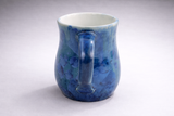 Back view of blue handmade mug showing handle and crystalline pattern