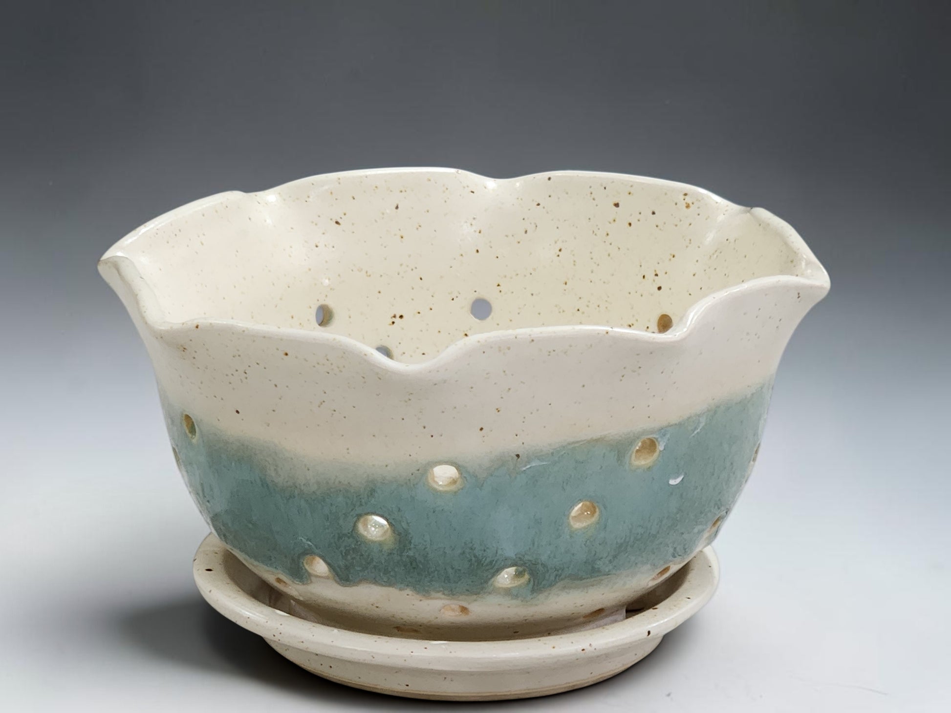 Handmade ceramic berry bowl with saucer in cream and aqua glaze front view