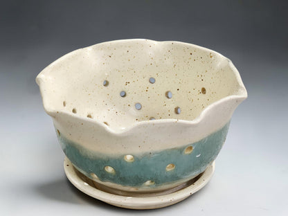 Pottery berry bowl with drainage holes and matching saucer in cream and aqua glaze