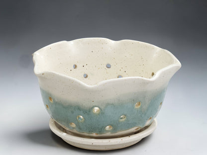 Handmade pottery berry bowl in cream glaze with aqua band and matching drip tray
