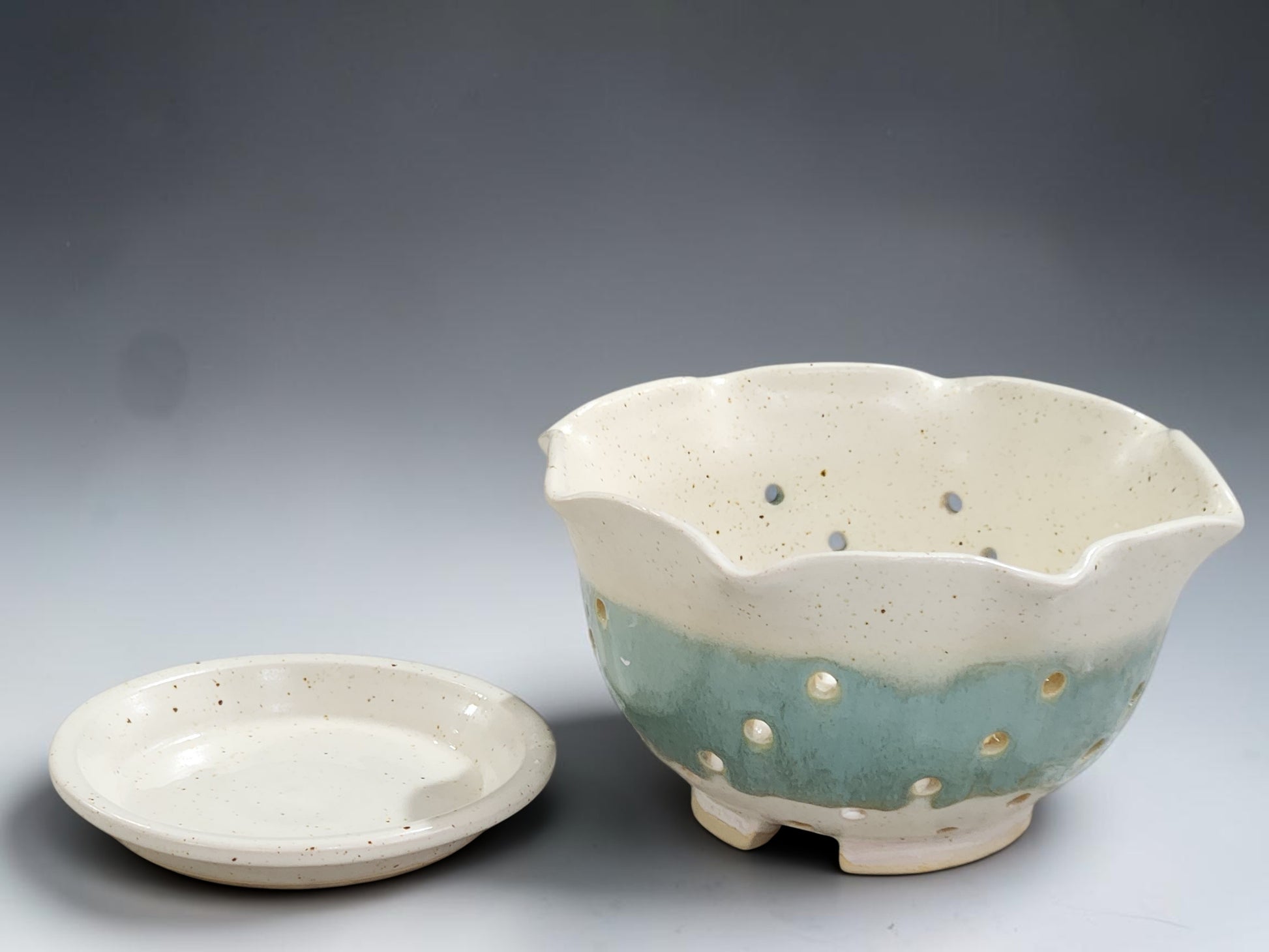 Ceramic fruit bowl with holes and saucer, handmade pottery berry bowl in soft coastal tones