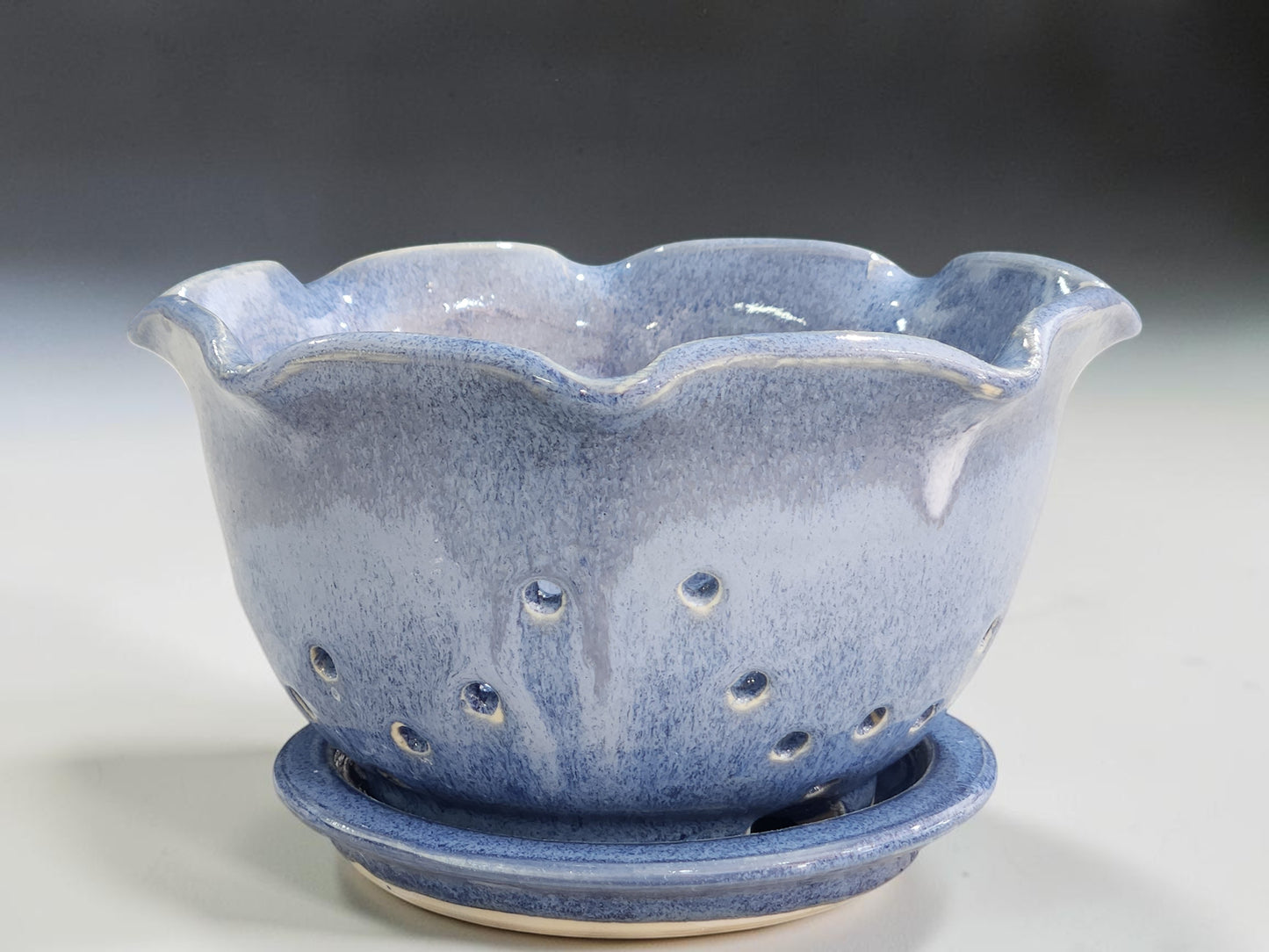 Handmade blue ceramic berry bowl with matching saucer