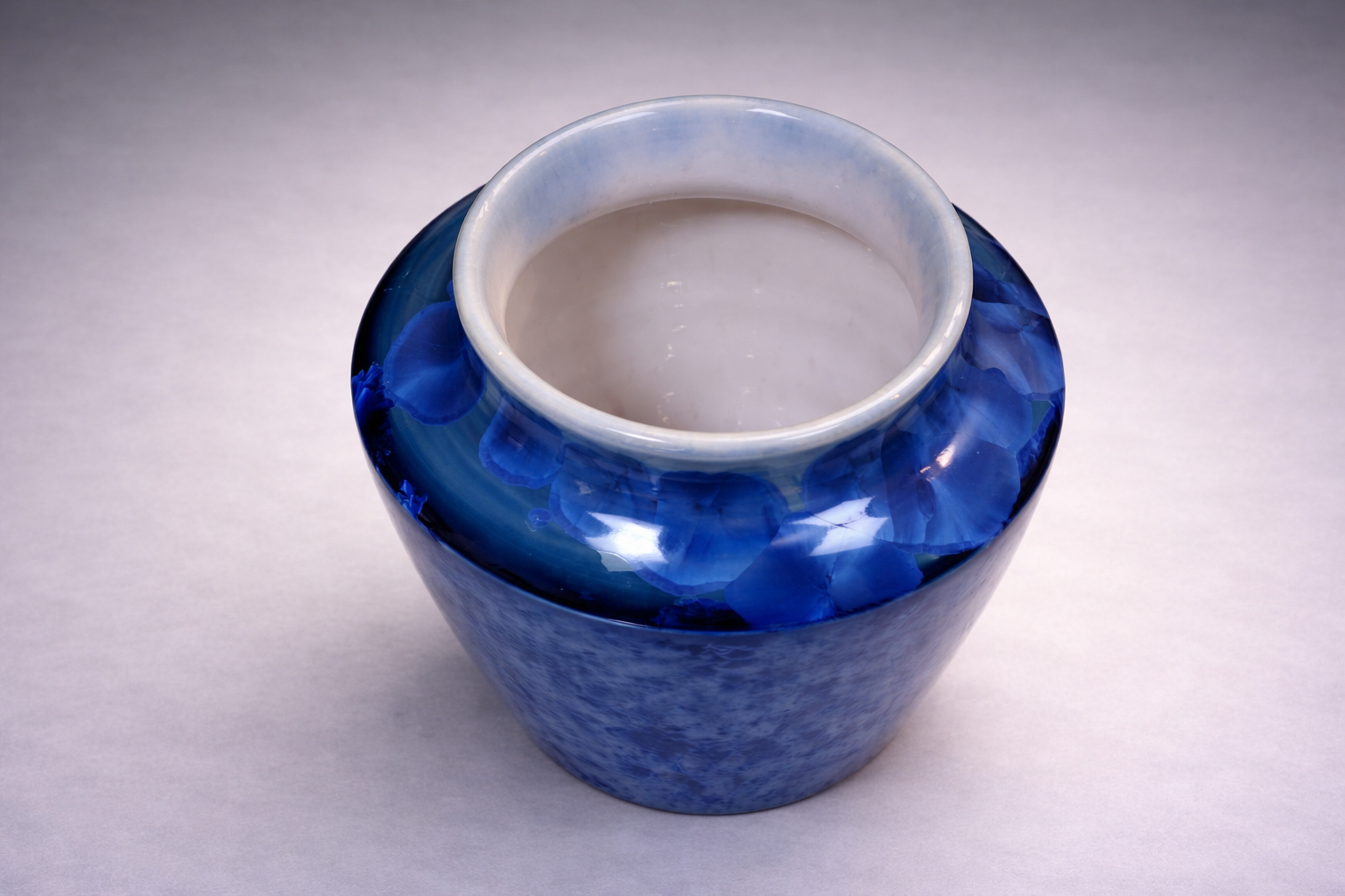 Decorative handmade ceramic vase in rich blue crystalline glaze
