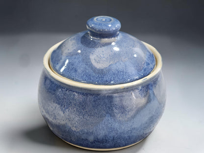 Handmade pottery lidded sugar bowl with rounded form and rich blue glaze variation