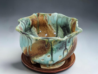 Handmade pottery colander bowl with drainage holes, matching drip tray and natural glaze variation