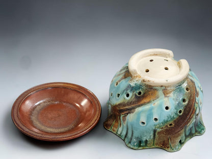 Handmade berry bowl and drip tray on grey studio background showing drainage hole pattern and layered Bush Creek glaze
