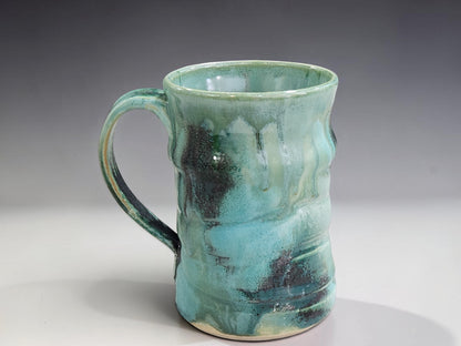 Handmade stoneware mug with flowing turquoise and earthy green glaze, crafted by Buxton Pottery in Melbourne Australia