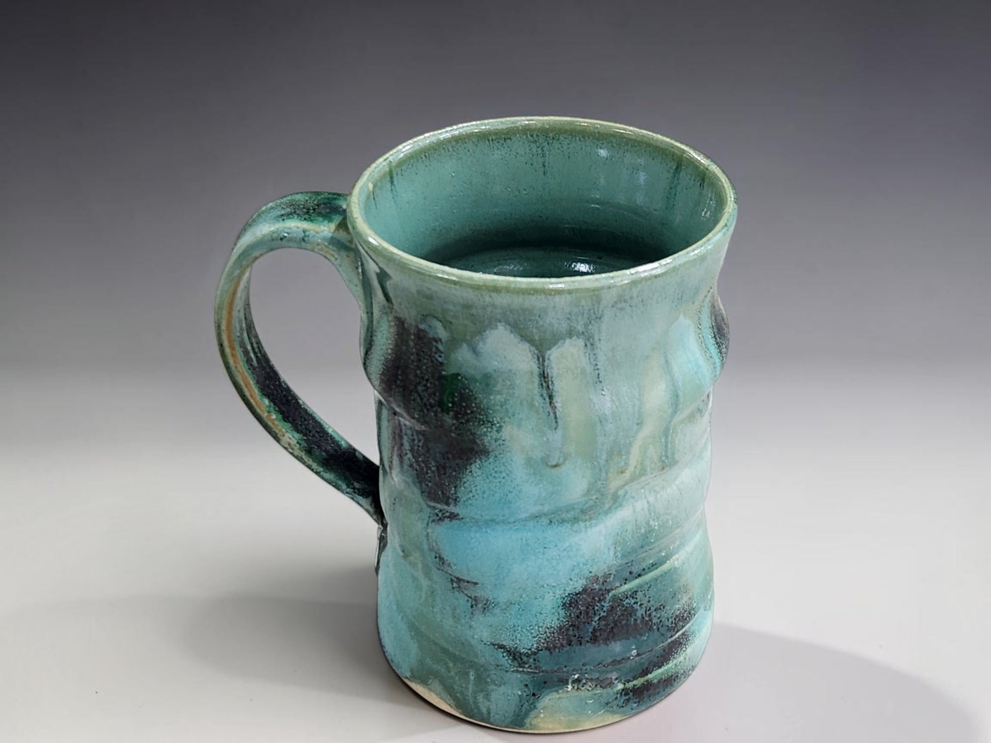 Bush Creek Collection handmade ceramic mug styled for morning coffee with French press and sweet pastry