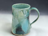 Handmade stoneware mug in turquoise green glaze with flowing dark glaze detail, made by Buxton Pottery in Melbourne Australia