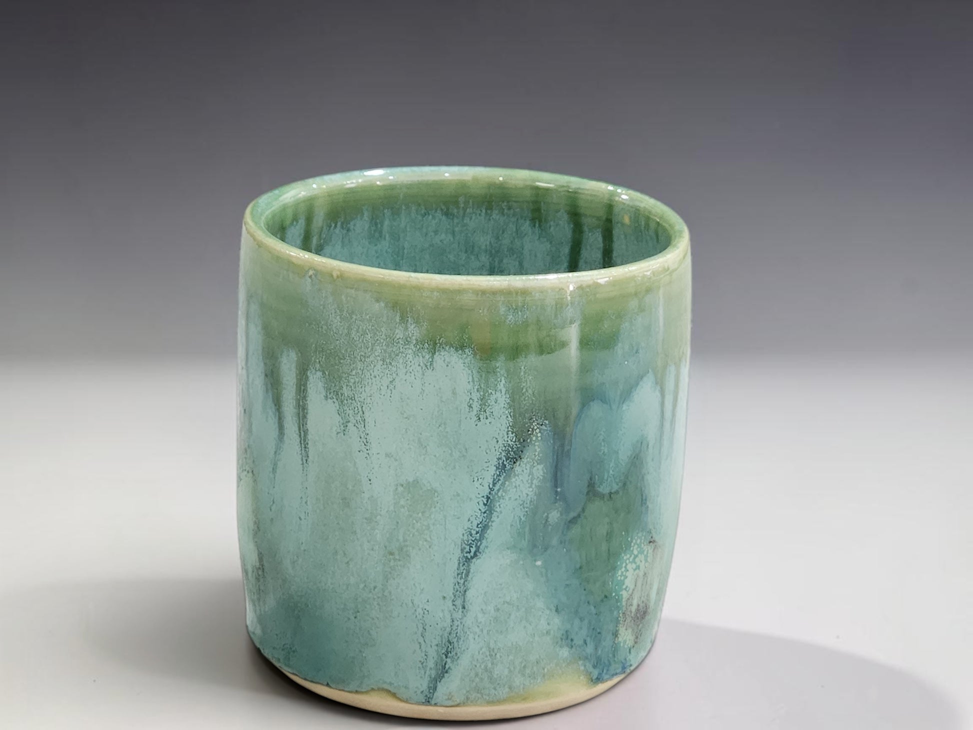 Handmade stoneware tumbler in soft green and aqua glaze, wheel-thrown by Buxton Pottery in Melbourne Australia