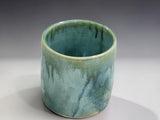 Bush Creek Collection ceramic tumbler with flowing green glaze and natural handmade variation