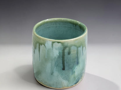 One-of-a-kind handmade ceramic tumbler with layered green, aqua and earthy glaze tones
