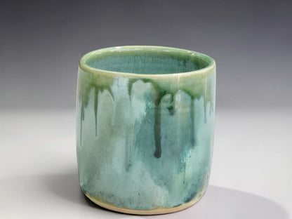 Small handmade stoneware tumbler in soft mist green glaze, a unique Australian pottery gift