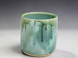 Small handmade stoneware tumbler in soft mist green glaze, a unique Australian pottery gift