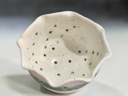 Handmade stoneware berry bowl with drainage holes and matching saucer