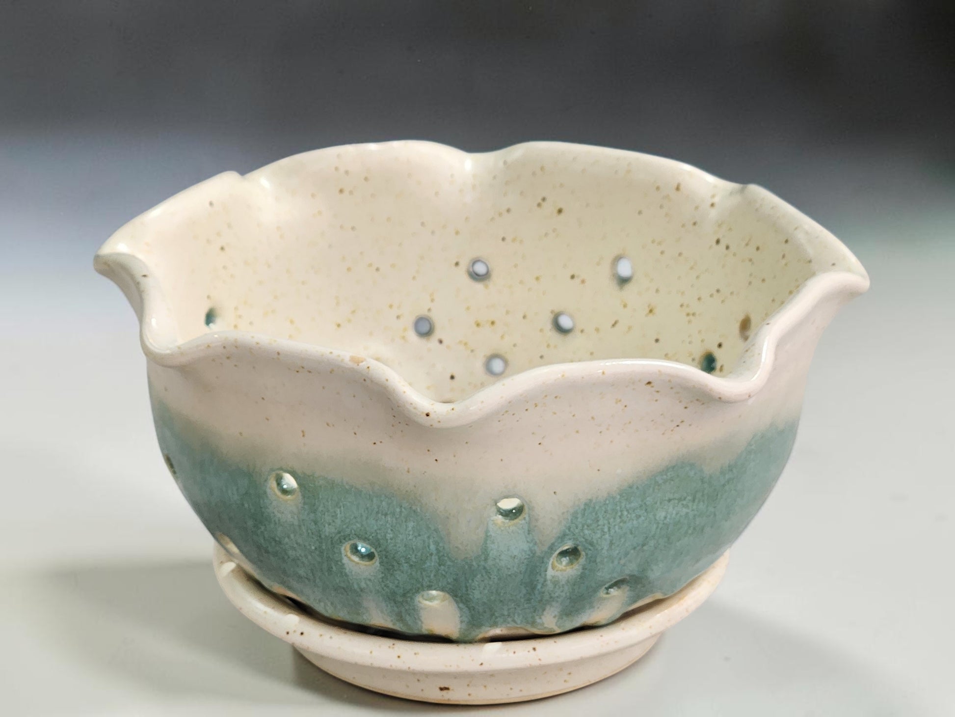 Ceramic berry bowl with scalloped rim and strawberries