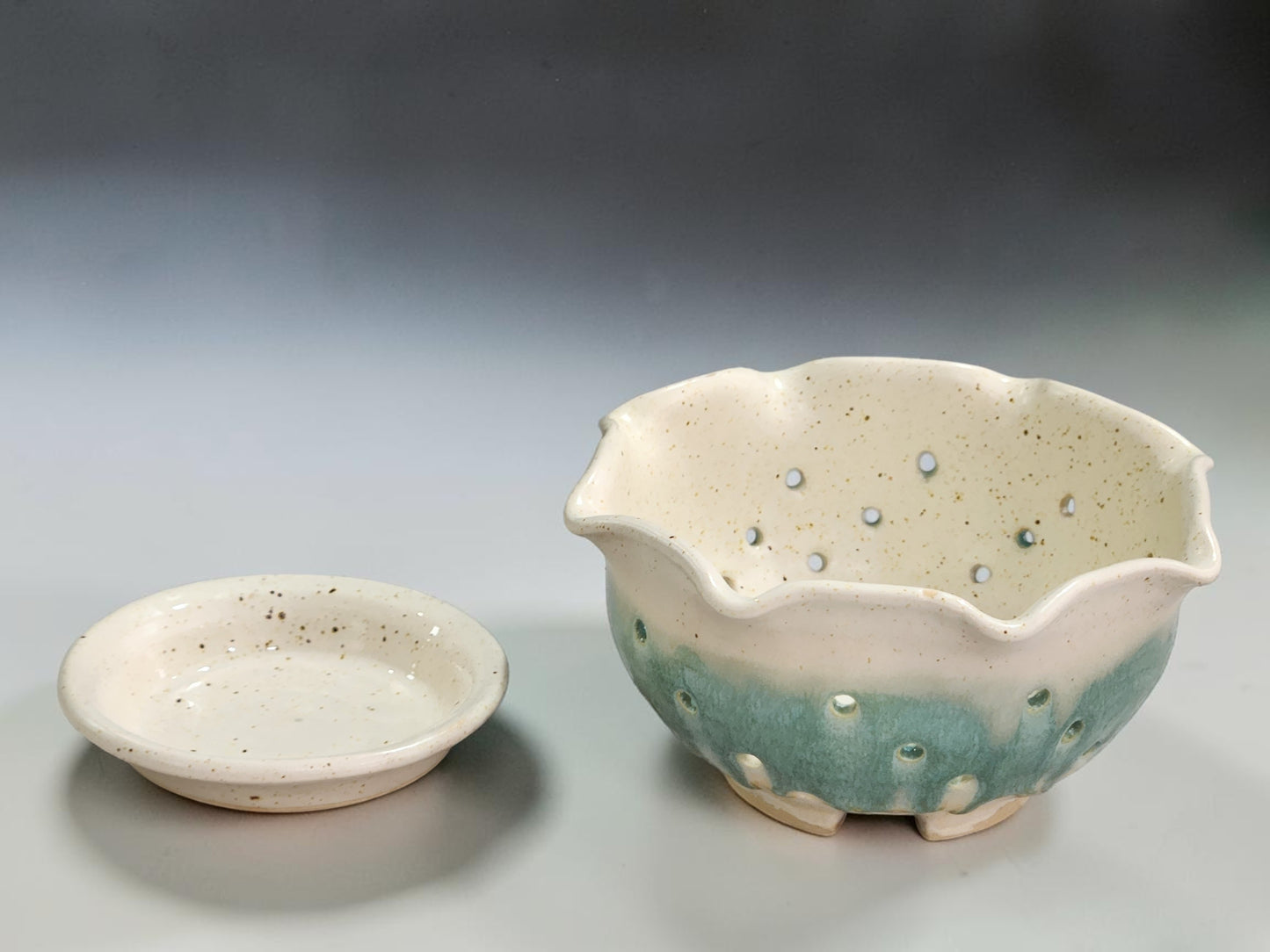 Speckled cream berry bowl with spearmint green glaze and saucer