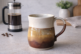 Extra large handmade ceramic coffee mug on a kitchen countertop with coffee pot, Australian stoneware pottery
