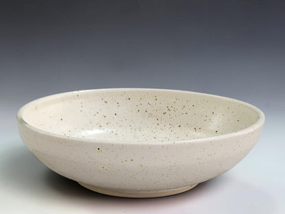 Handmade ceramic bowl 20cm wide with speckled cream glaze and green glaze detail
