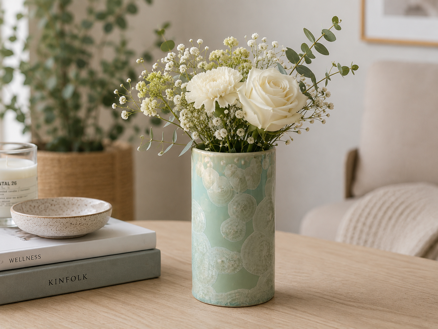 Small decorative handmade pottery crystalline Vase with a small posey of flowers.
