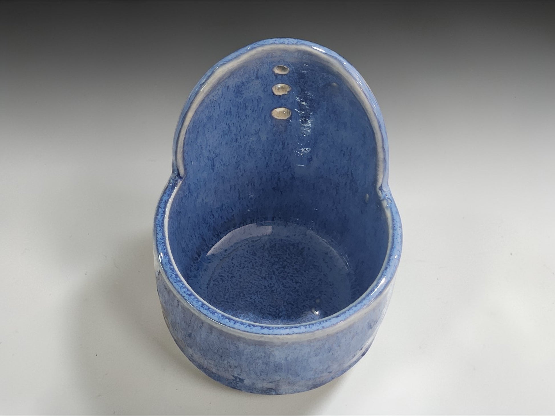 Interior of Australian handmade pottery herb stripper in soft blue glaze