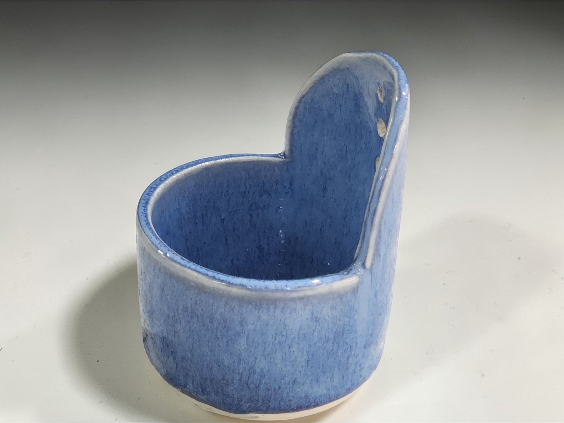  side view of Australian handmade pottery herb stripper in soft blue glaze made in Melbourne