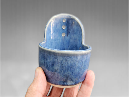 Handmade blue ceramic herb stripper with rosemary stem