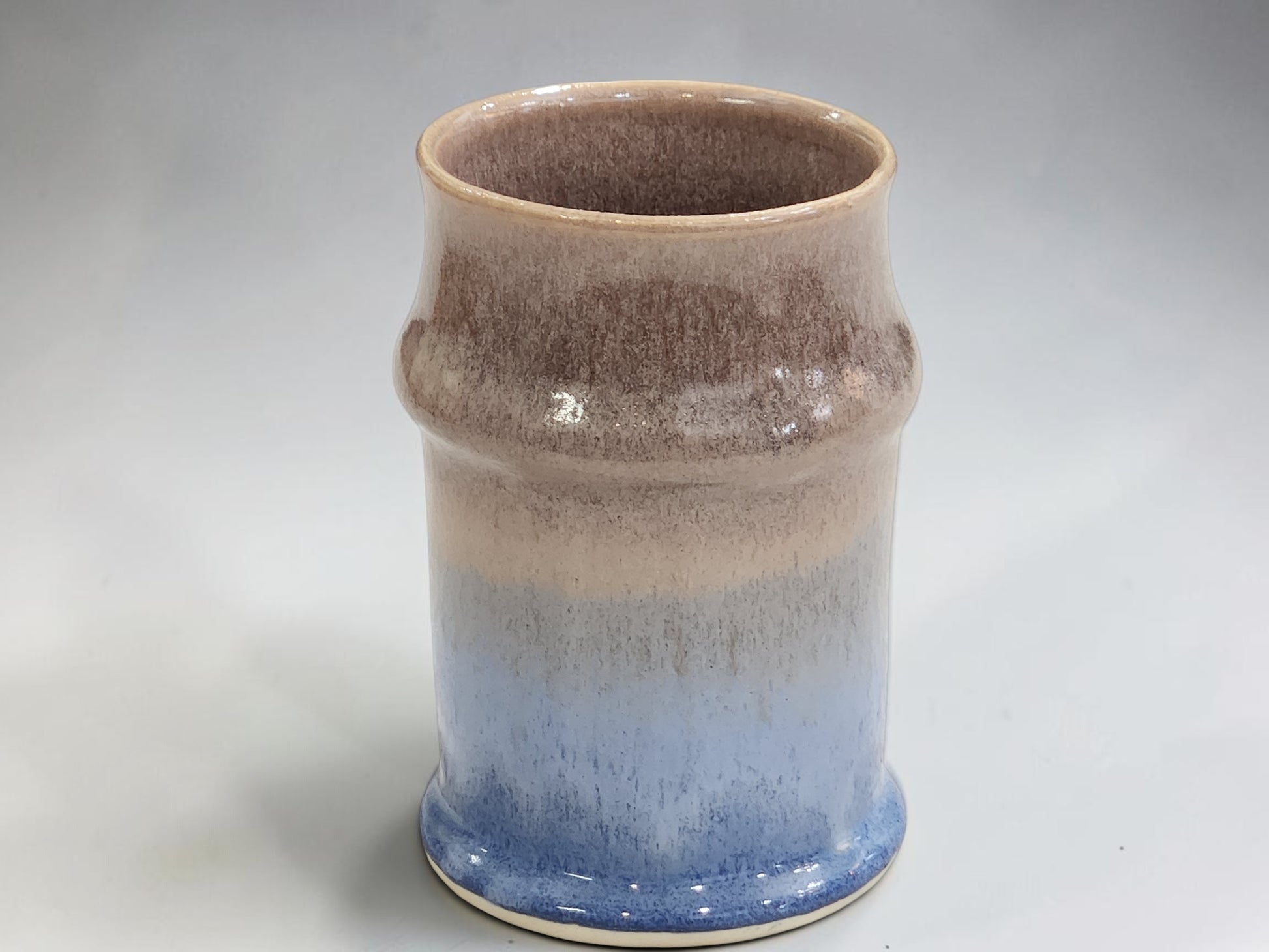 Handmade ceramic tankard with layered blue cream and brown glaze