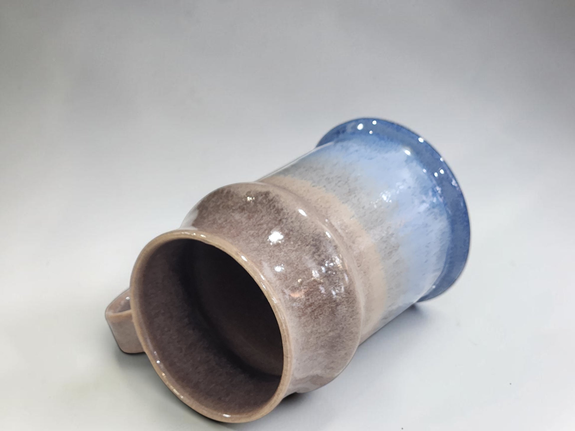 Handmade blue beer tankard with glossy oatmeal interior