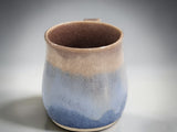 Blue and oatmeal ceramic coffee mug handcrafted pottery studio photograph