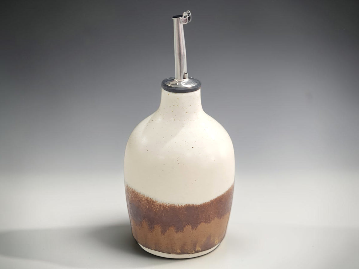 Australian handmade pottery oil dispenser in cream and warm brown