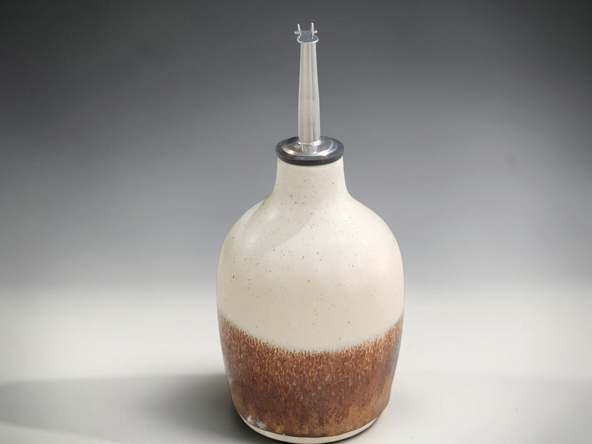 Handmade ceramic oil pourer with speckled cream glaze