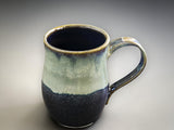 Handmade pottery mug with dark brown and cream glaze