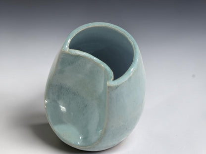 Top view of handmade altered ceramic vase showing unique opening.