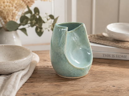 Handmade seafoam altered stoneware vase front view showing sculptural opening.